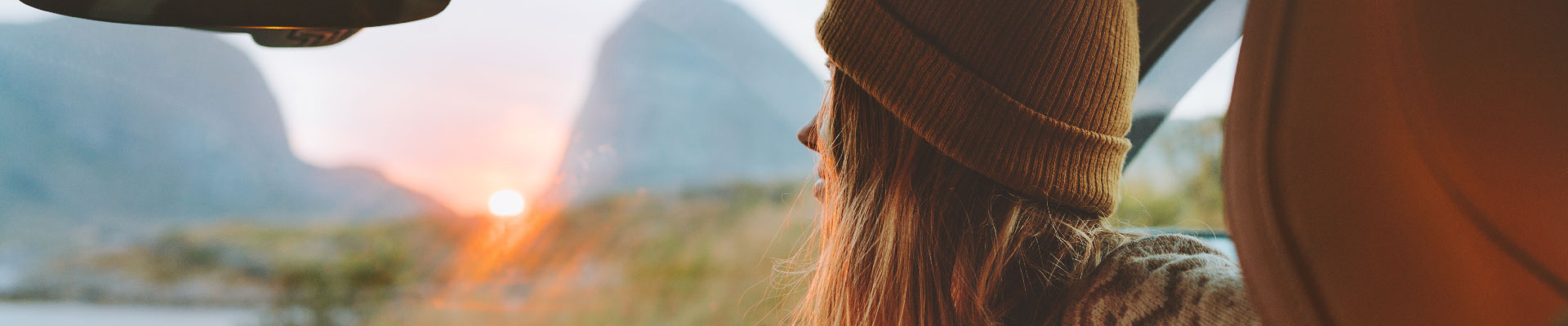 Auto_Refi_Landing Page Banner_1920x400 Woman looking out car windshield